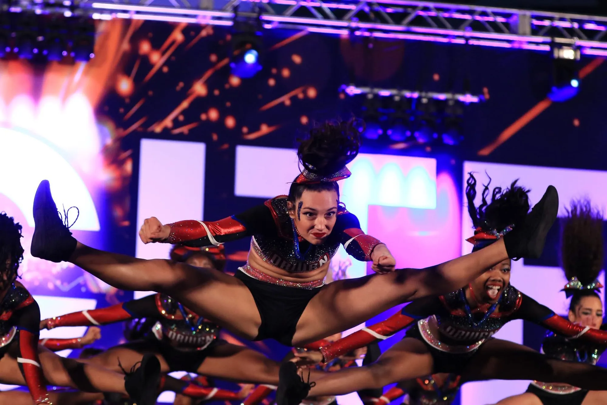 Driven Athletics all-star team hitting a pyramid under competition lights