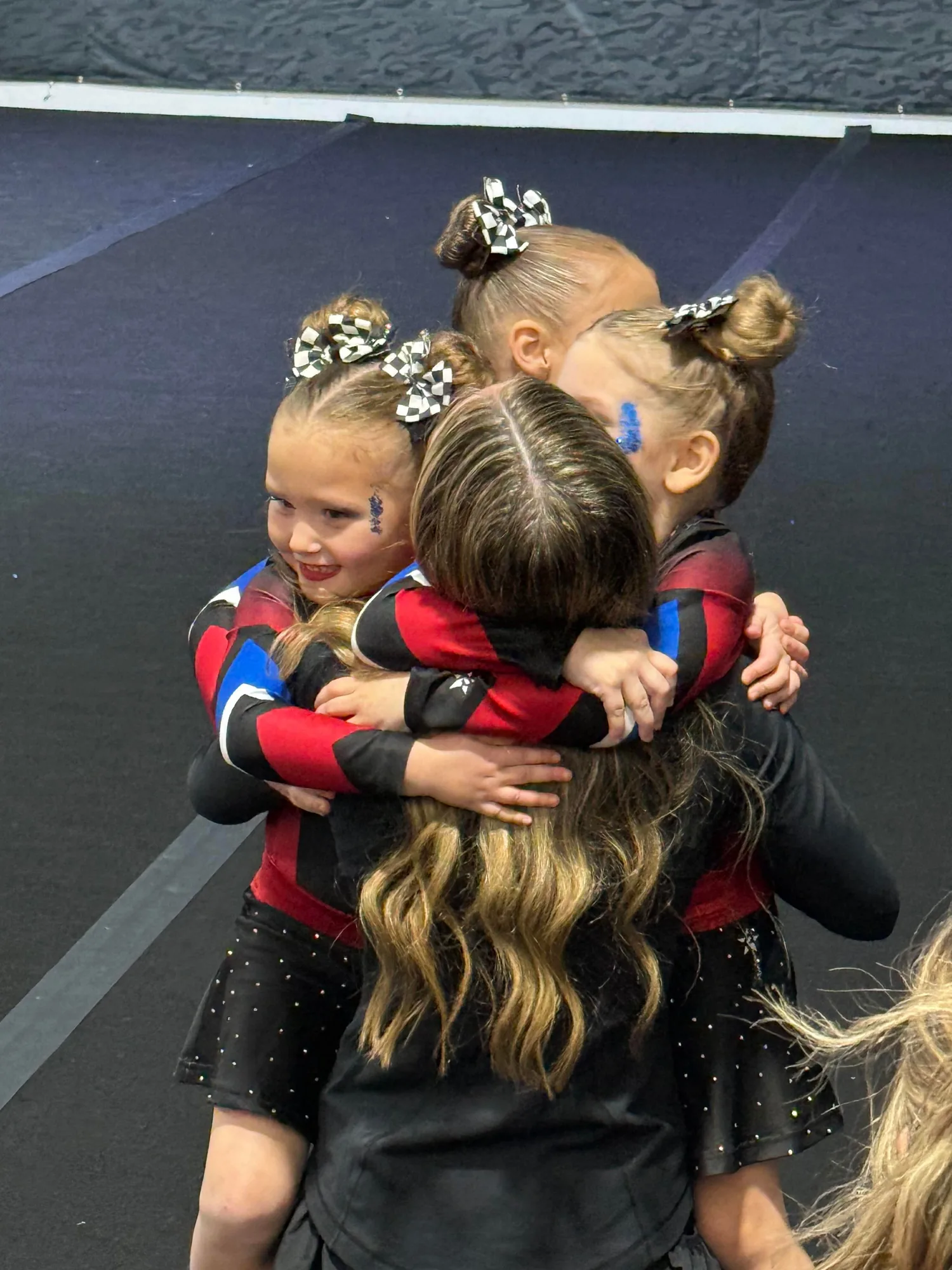 Teammates embrace after a performance
